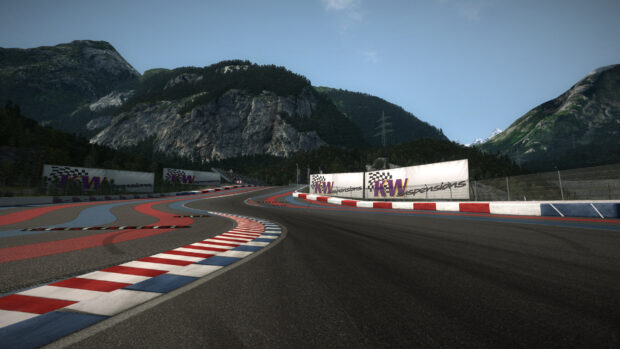 A race track winding through the mountainous landscape under a clear sky, 2K Desktop Wallpaper