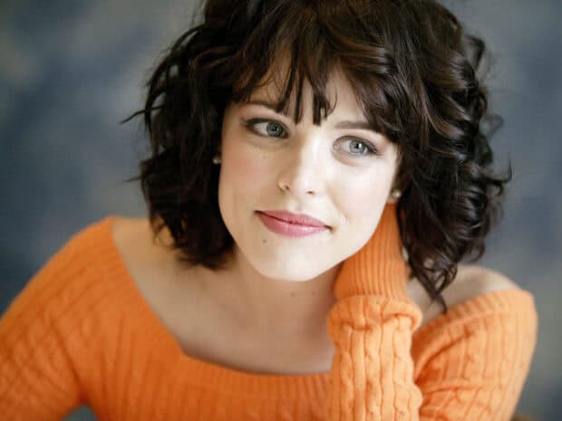 Rachel Mcadams wallpapers captures a close up portrait with a soft expression wearing an orange sweater, HD Desktop Wallpaper