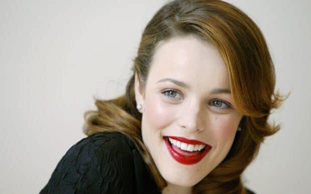 Rachel Mcadams wallpapers show a close up of a woman smiling with red lipstick and styled hair, 2K Desktop Wallpaper