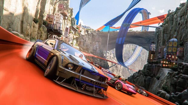 A group of Hot Wheels cars racing on an orange stunt track through a rocky canyon, 4K Desktop Wallpaper