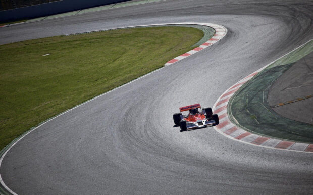 A racing car is taking a sharp turn on the race track with visible tire marks, HD Desktop Wallpaper
