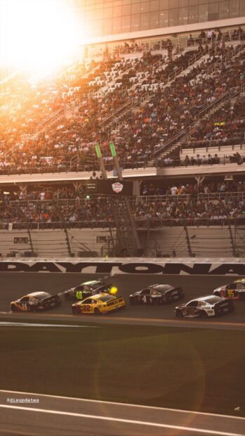 A race with multiple racing cars close together on the track under bright sunlight, HD Mobile Wallpaper