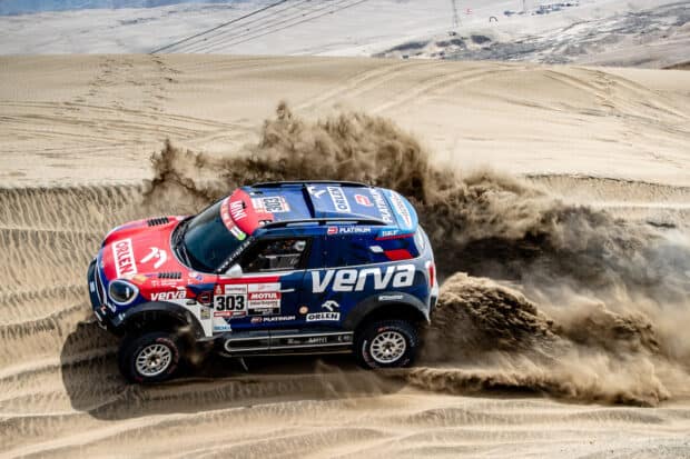 A rally raid car kicks up a large cloud of sand while racing through the desert terrain, HD Desktop Wallpaper