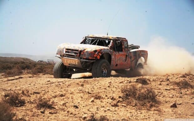 Rally raid desert truck competes in dusty offroad terrain, 2K Desktop Wallpaper