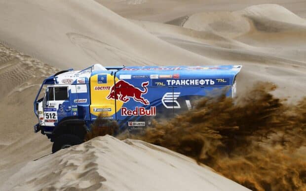 A rally raid truck kicks up a large dust cloud while racing in the desert, HD Desktop Wallpaper