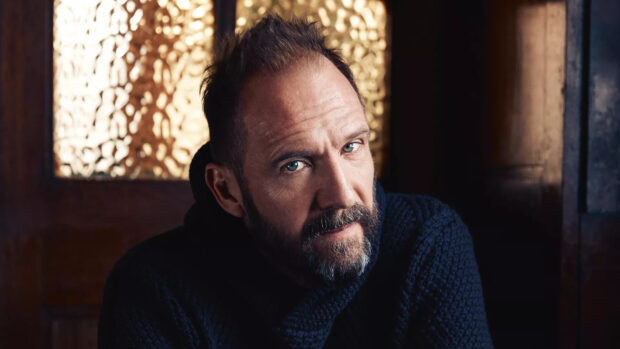 Ralph Fiennes close up portrait with intense gaze and textured background, HD Desktop Wallpaper