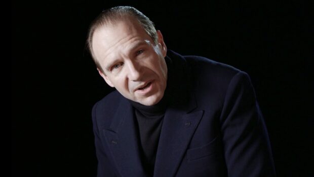 Ralph Fiennes is wearing a dark jacket and turtleneck with a serious expression, HD Desktop Wallpaper
