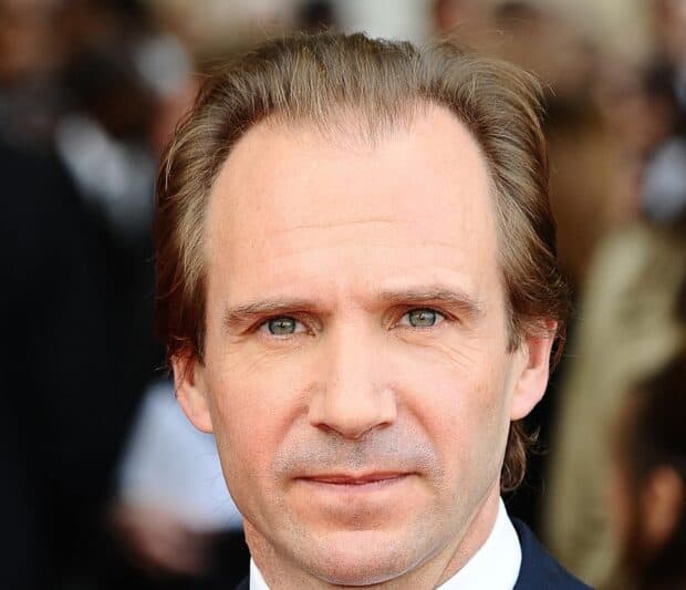 A close up portrait of Ralph Fiennes with a serious expression and clear blue eyes, HD Desktop Wallpaper