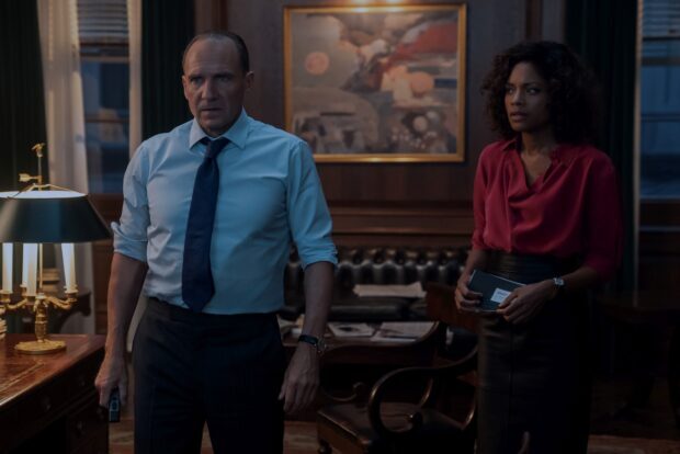 A tense moment featuring Ralph Fiennes and a woman in a formal setting, HD Desktop Wallpaper