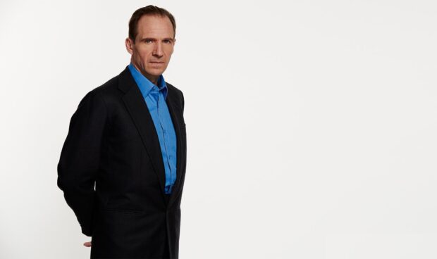 A serious portrait of Ralph Fiennes wearing a black suit with a blue shirt, HD Desktop Wallpaper
