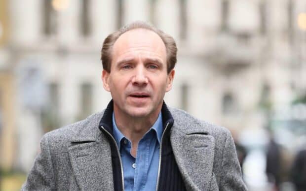 Ralph Fiennes looks concerned walking outdoors in the city, HD Desktop Wallpaper