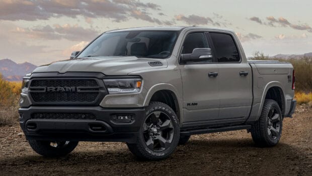 A grey Ram pickup stands on a dirt road with mountains and cloudy sky in the background, HD Desktop Wallpaper