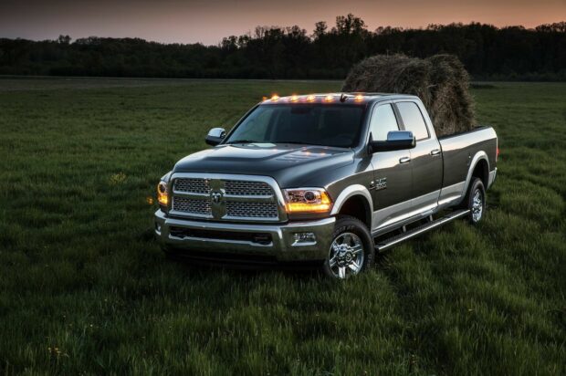 A Ram pickup is parked on a green field carrying hay under the evening sky, HD Desktop Wallpaper