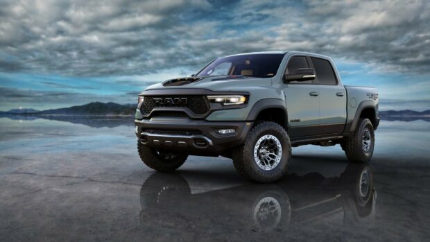 A gray Ram pickup is parked on a reflective surface under a cloudy sky, HD Desktop Wallpaper