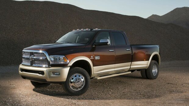 A Ram pickup truck with brown and beige paint is parked on gravel near a hillside, HD Desktop Wallpaper