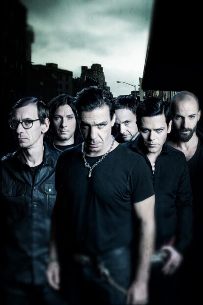 The Rammstein band stands together in a dark cityscape setting under a cloudy sky, HD Phone Wallpaper