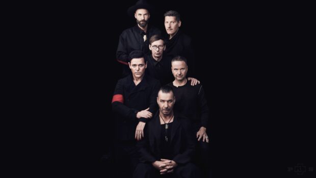 The members of Rammstein are posing together in a dark setting with serious expressions, 4K Desktop Wallpaper