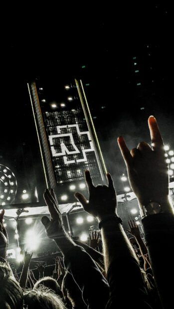 The Rammstein wallpapers show fans raising hands with horns at a concert stage, 2K Phone Wallpaper