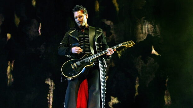 A guitarist from the band Rammstein plays an electric guitar during a live concert performance, HD Desktop Wallpaper