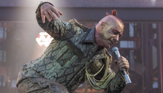 The image captures the Rammstein lead singer performing energetically on stage with a microphone, 2K Desktop Wallpaper