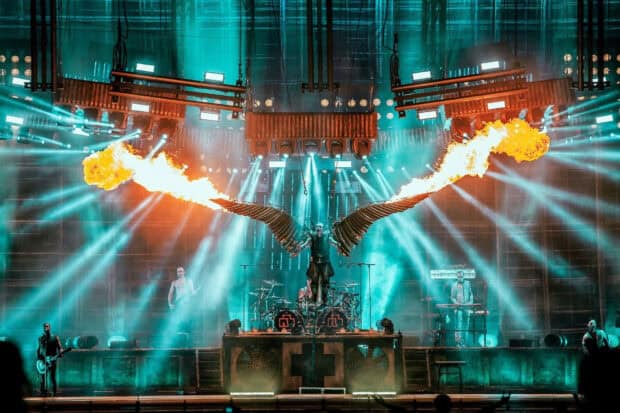The Rammstein band performs with large fiery wings and dramatic lighting effects on stage, HD Desktop Wallpaper