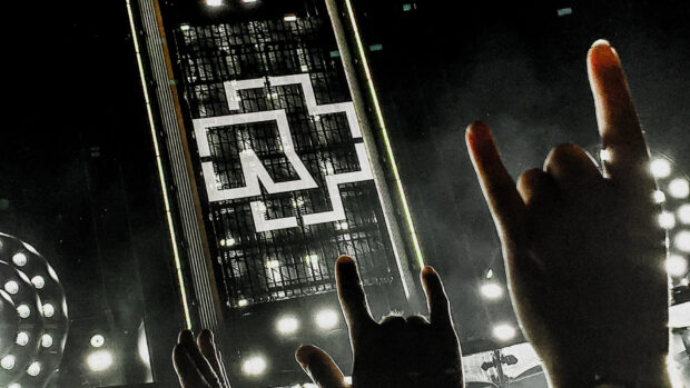 The image shows fans making the horn hand gesture during a Rammstein concert stage performance, HD Desktop Wallpaper