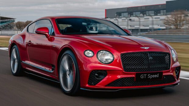 A red Bentley Continental GT with spinning wheels drives fast on a racetrack, HD Desktop Wallpaper