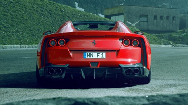 A red Ferrari 812 Gts is parked on a mountain road near a building, HD Desktop Wallpaper