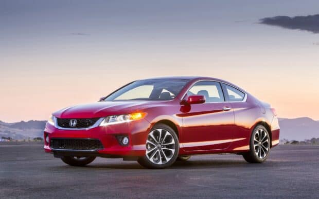 A red Honda Accord coupe is parked on open asphalt with mountains in the distance at sunset, 2K Desktop Wallpaper