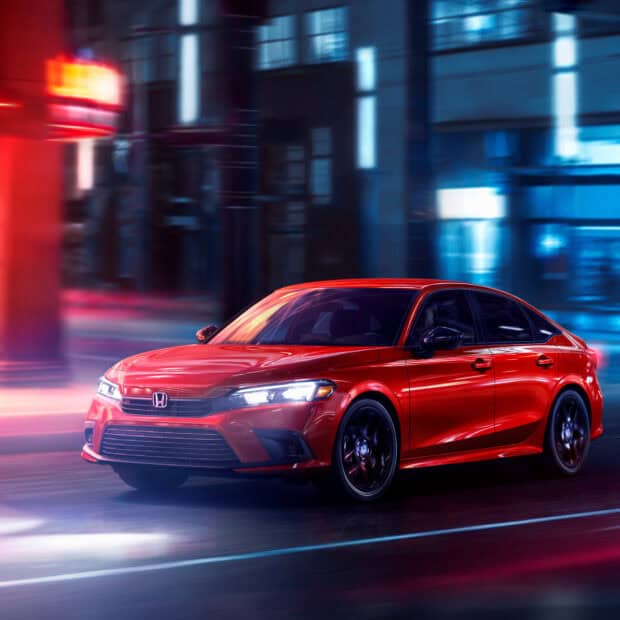 A red Honda Accord drives swiftly through colorful city lights at night showing its sleek design, HD Desktop Wallpaper