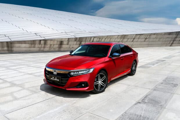 A red Honda Accord is parked on a tiled surface with a modern building in the background, 2K Desktop Wallpaper