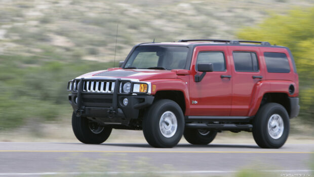 A red Hummer H3 is driving fast along a highway with a blurred natural background, HD Desktop Wallpaper