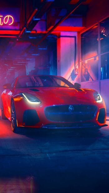 A red Jaguar F Type is parked inside a neon lit garage with colorful lighting, HD Phone Wallpaper