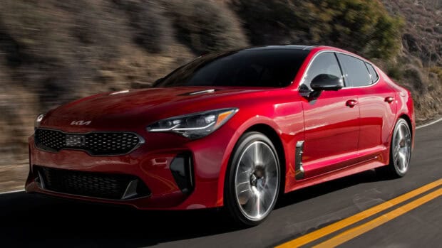 A red Kia Stinger is driving fast along a winding road with blurred background, HD Desktop Wallpaper