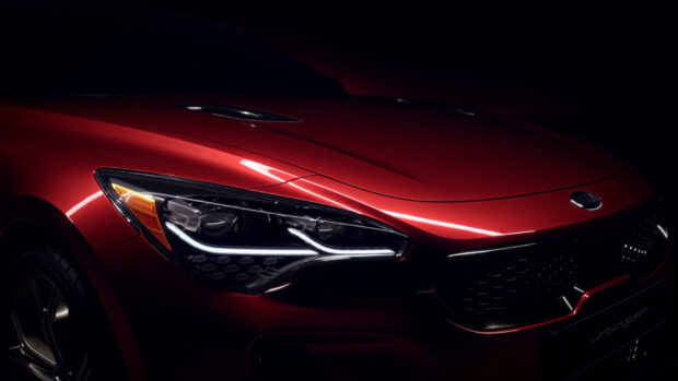 The red Kia Stinger displays a sleek and modern front with distinctive lights, HD Desktop Wallpaper