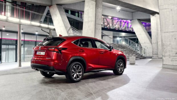 A red Lexus NX is parked inside a contemporary building with concrete pillars and illuminated stairs, 4K Desktop Wallpaper