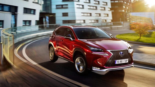 A red Lexus Nx drives smoothly on a curved city street with modern buildings, 4K Desktop Wallpaper
