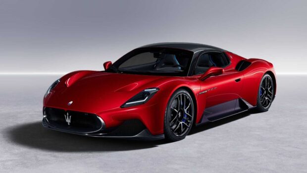 A red Maserati MC20 sports car is displayed in a clean studio environment, HD Desktop Wallpaper
