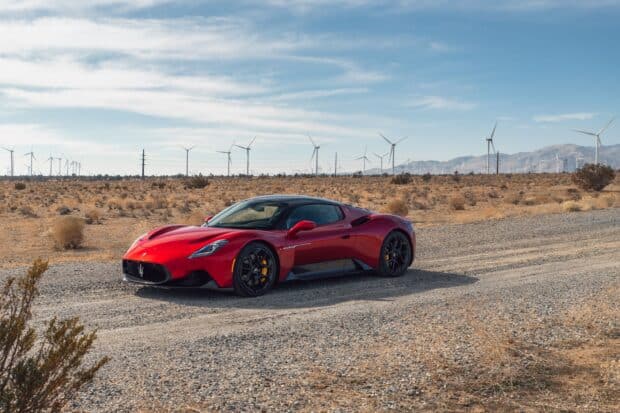 A sleek Maserati MC20 driving through dry landscape, 2K Desktop Wallpaper