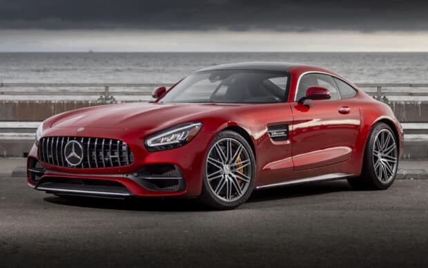 A red Mercedes Benz AMG GT is parked by the ocean under a cloudy sky, HD Desktop Wallpaper