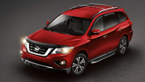 A red Nissan Pathfinder is shown from an angled front view with its headlights on, 2K Desktop Wallpaper