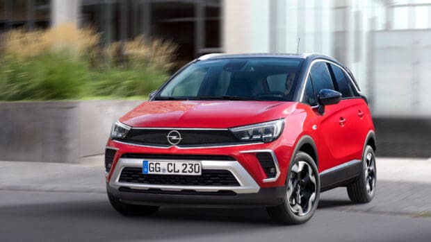 A red Opel Crossland is driving fast on an urban street with blurred background, 4K Desktop Wallpaper