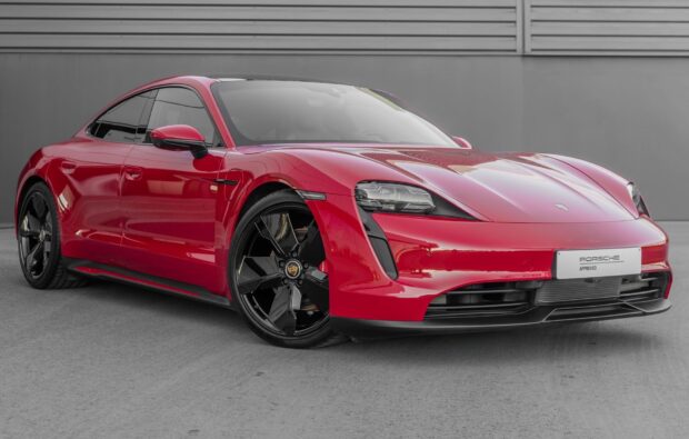 A red Porsche Taycan is parked showing its front and side profile, HD Desktop Wallpaper