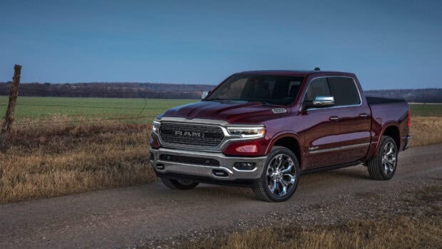 A red Ram pickup truck is parked on a rural dirt road with fields in the background, 4K Desktop Wallpaper