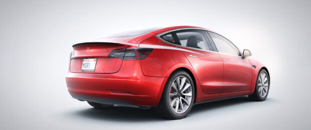 A red Tesla Model 3 is shown from the back in a bright studio setting, 2K Desktop Wallpaper