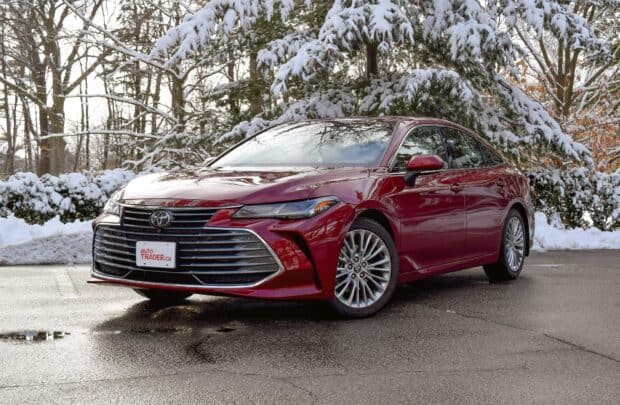 A red Toyota Avalon parked outside with snow covered trees in the background, HD Desktop Wallpaper