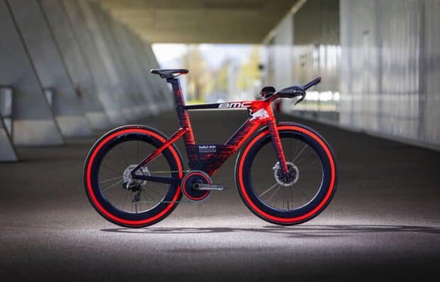 A red and black BMC bike stands in a tunnel with detailed markings, 2K Desktop Wallpaper