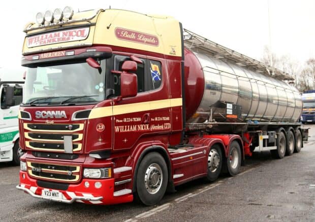 A red and cream Scania truck with a tanker trailer is parked on the roadside, HD Desktop Wallpaper