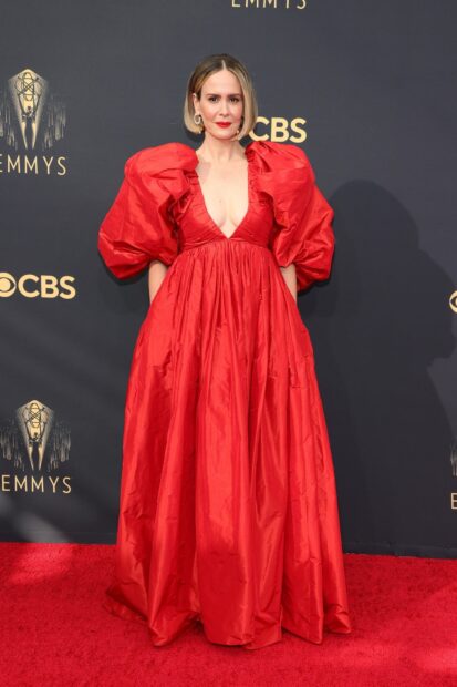A woman wearing a red gown stands on the red carpet at the Emmy Awards event, HD Desktop Wallpaper