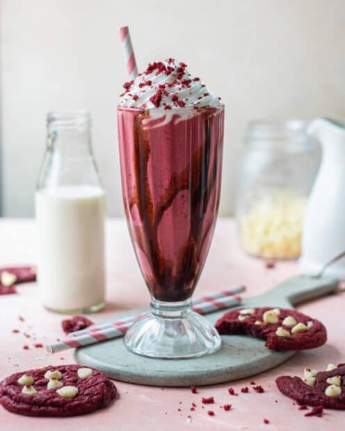 A red velvet milkshake topped with whipped cream is surrounded by cookies and milk, 2K Mobile Wallpaper